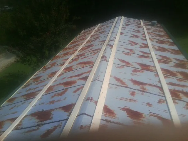 Rusted metal roof panels with new wood purlins before replacement — Storm Damage Roof Repair in Monmouth Junction by Roofing Brothers