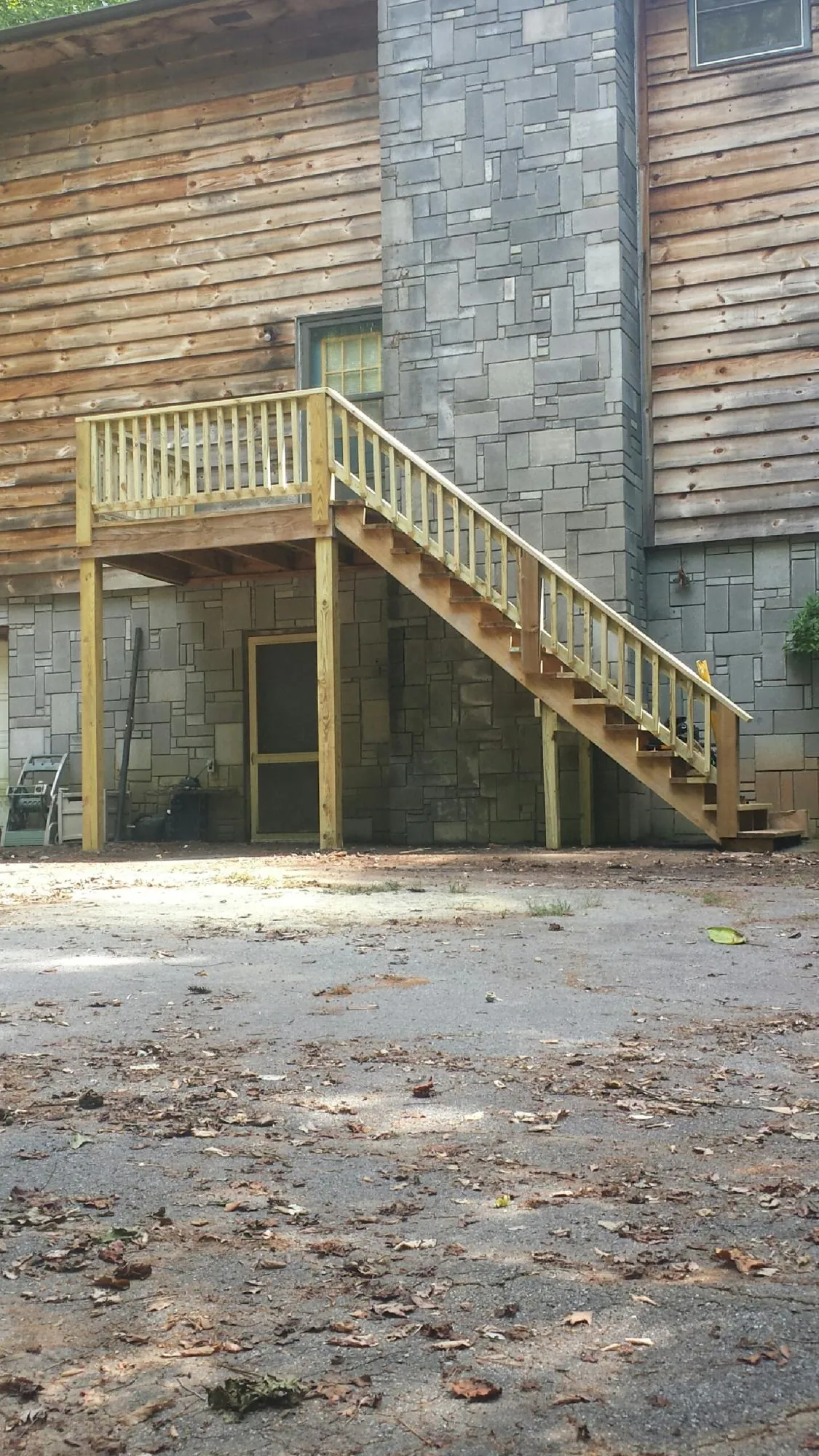 New pressure treated deck and stair landing on a log home in Monmouth Junction